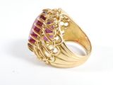 an image of a gold ring with a pink stone in it