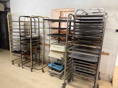 many trays of food that are sitting on a cart