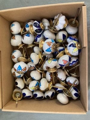 a box full of white and blue ceramic knobs