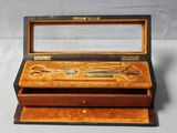 a wooden box with a pair of scissors in it