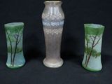 three vases sitting next to each other on a black background