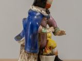 a figurine of a man sitting on a tree stump