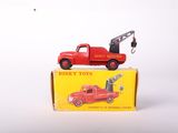 a red toy truck with a crane on top of it