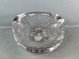 a clear glass bowl with bubbles in it on a table