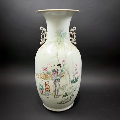 a white vase with a painting on it sitting on a table