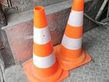 two orange and white cones sitting on the floor of a truck