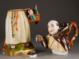 two ceramic figurines of a man and a woman