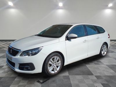 a picture of a white car that is parked in a garage