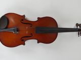 an old violin sitting on top of a white surface