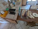 a table with a laptop on top of it in a kitchen