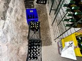 a person that is standing next to a rack of wine bottles