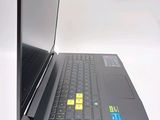 a black laptop with a yellow sticker on the screen