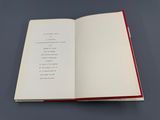 an open book sitting on top of a table next to a gray table