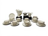 a lot of coffee cups and saucers sitting on a table