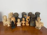 a lot of statues that are on a wooden table