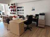 a desk with two chairs and a computer on it