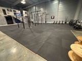 an image of a gym room with a row of exercise equipment