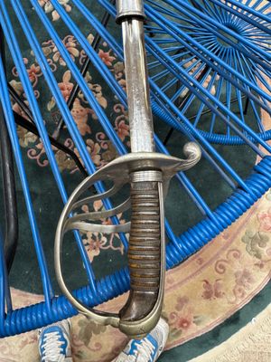 a close up of a blue umbrella with a sword on it