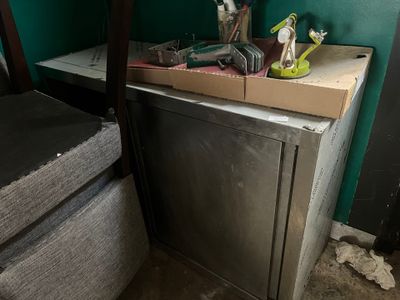 an image of a kitchen with a refrigerator and a chair