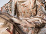 an image of a statue of a woman holding a baby