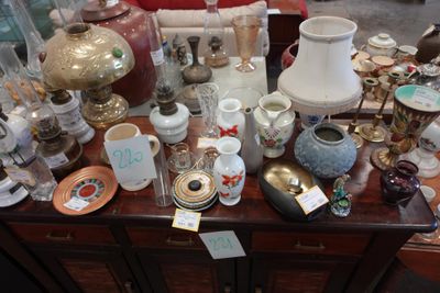 une table sur laquelle sont posés de nombreux vases et autres objets