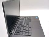 a laptop that is open on a white surface