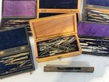 many different types of sewing needles in a wooden box