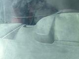 smoke billowing out from the back of a boat on the water