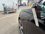 a sign on the side of a car with a shopping cart in the background
