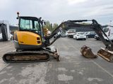 a small excavator that is parked in a parking lot