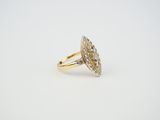 a yellow gold ring with a diamond cluster on top of it