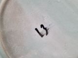 a white plate with a smiley face painted on it