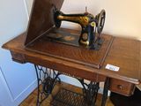 an old sewing machine sitting on a table in a room