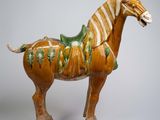 a statue of a horse with a saddle on it ' s back