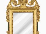 miroir doré et vert surmonté d'un oiseau