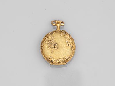 a gold pocket watch with a floral design on the front