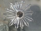 a glass flower that is sitting on a table