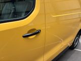 a yellow van that is parked in a parking lot