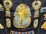 a black scarf with a picture of an egyptian mask on it