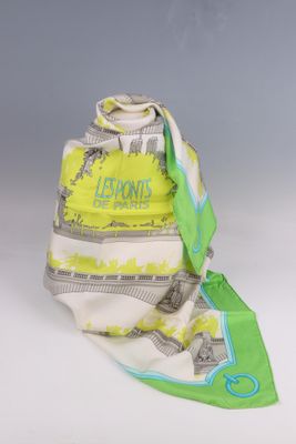 yellow and white scarf with green trim on a gray background