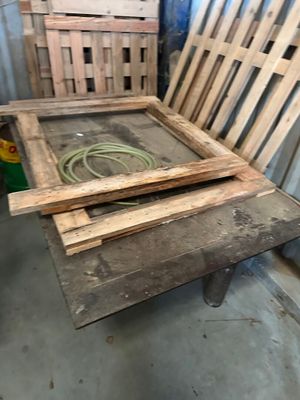 two wooden pallets stacked on top of each other in a room