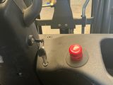 an image of a forklift with a red button