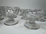 six glass goblets sitting on top of a white table
