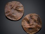two pieces of wood are sitting on top of a black surface