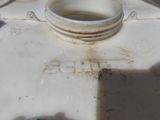 a close up of a white tank with a hole in it