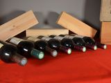 several bottles of wine are lined up on a red table cloth