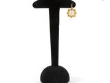 a close up of a pair of earrings on a stand