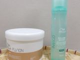 a bottle of lotion and a container of lotion sitting on a table