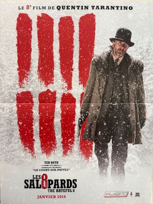 une affiche de film représentant un homme en chapeau et manteau, debout dans la neige