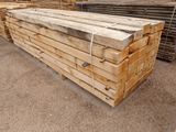 a large pile of wooden planks stacked on top of each other